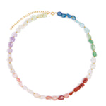 A beaded necklace with faceted, irregular gemstone beads arranged in a rainbow sequence, featuring a gold-tone chain extender clasp, shown on a plain white background.