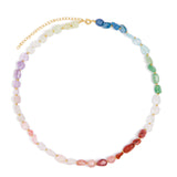 A beaded necklace with faceted, irregular gemstone beads arranged in a rainbow sequence, featuring a gold-tone chain extender clasp, shown on a plain white background.