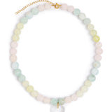 A pastel beaded necklace with round stones in soft pink, mint green, and pale yellow, accented by a gold-tone clasp and extender chain, with a clear heart-shaped pendant at the center, shown on a plain white background.