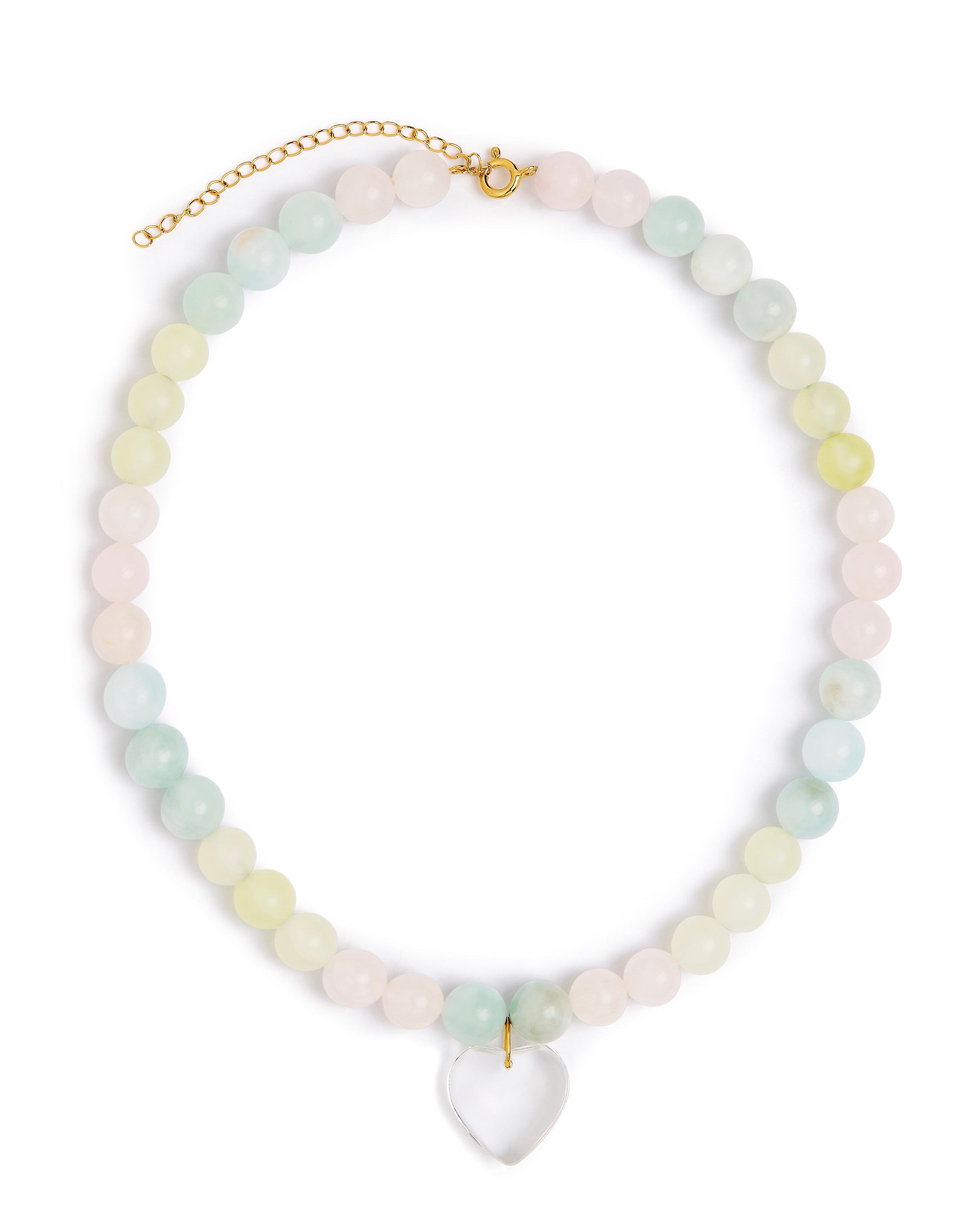 A pastel beaded necklace with round stones in soft pink, mint green, and pale yellow, accented by a gold-tone clasp and extender chain, with a clear heart-shaped pendant at the center, shown on a plain white background.